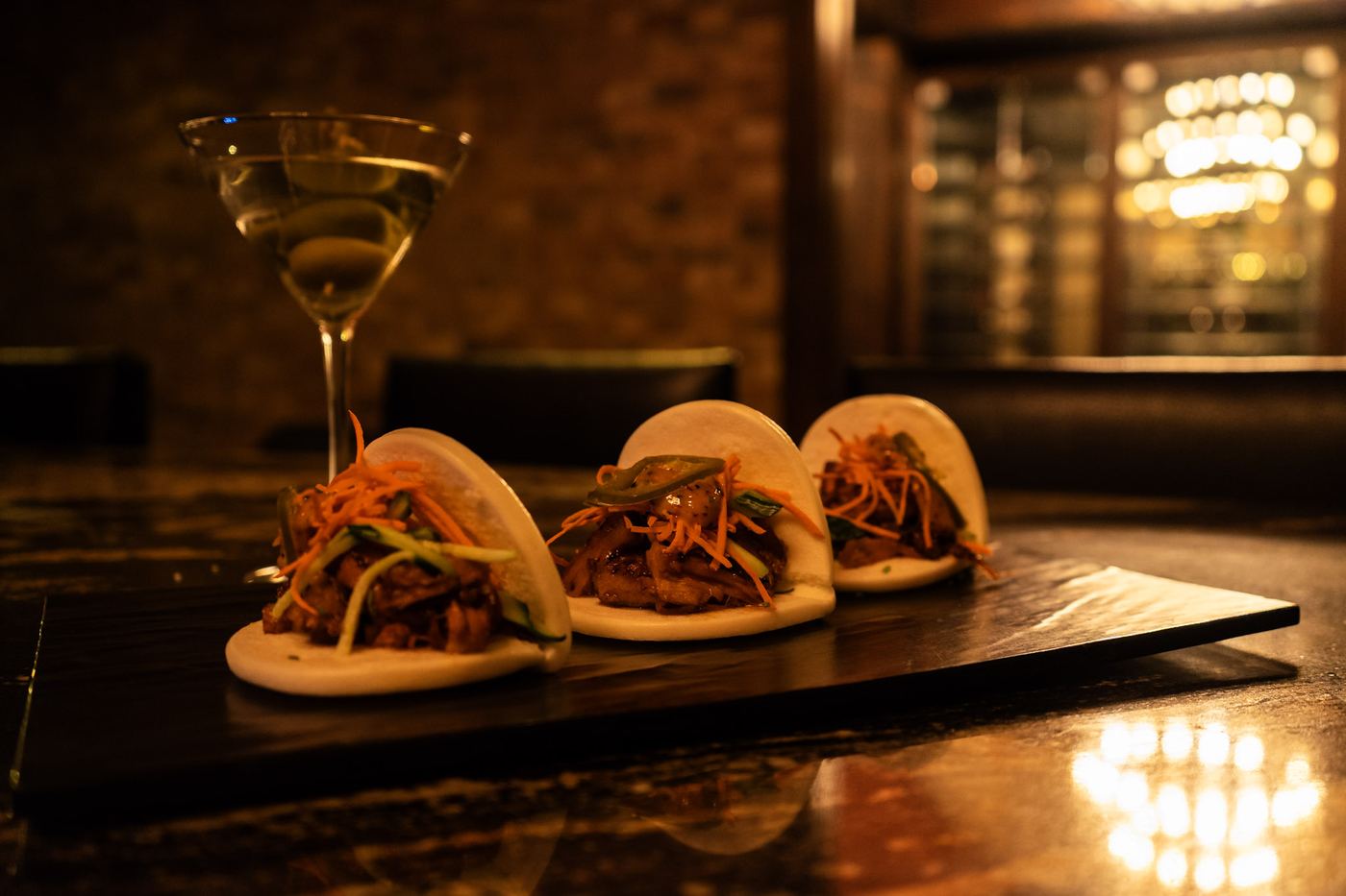 Steamed bao buns with a martini on the bar