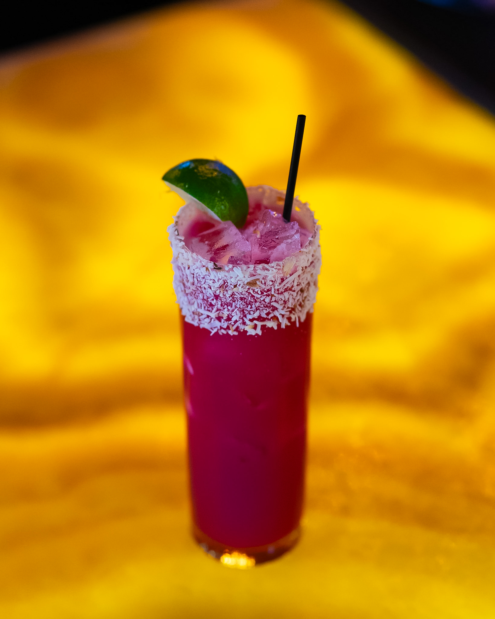 Coconut-rimmed magenta house cocktail