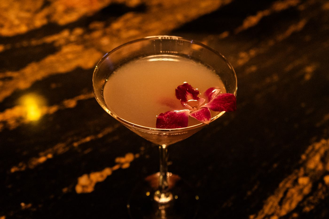 Martini garnished with an orchid petal