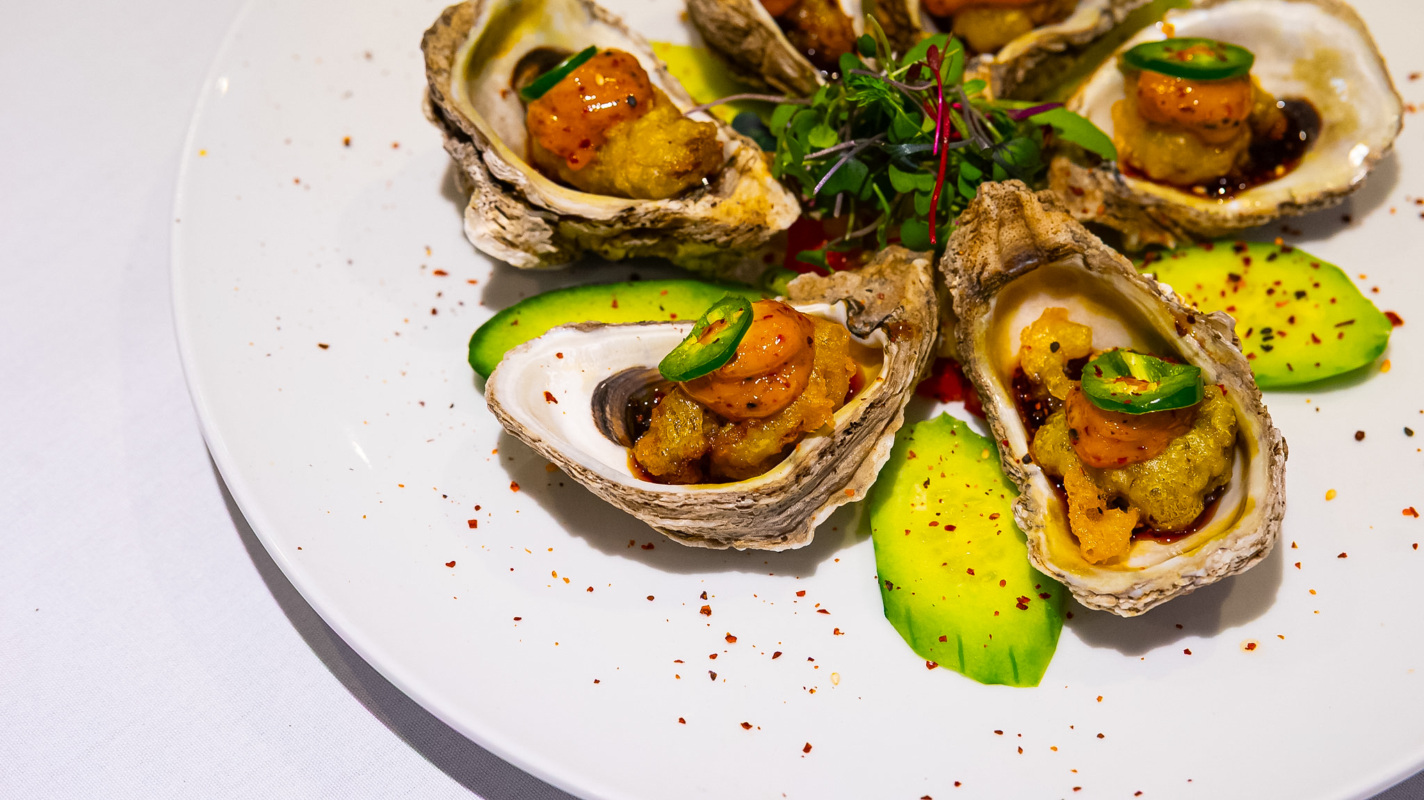 Chef's plate of spicy shrimp oysters, avocado, and micro greens at Vintage 423
