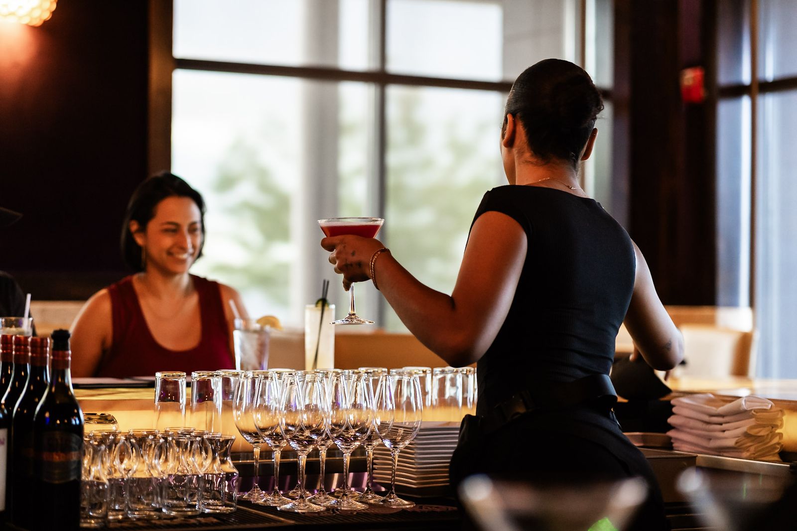 Bartender serving a cocktail to a guest at the bar