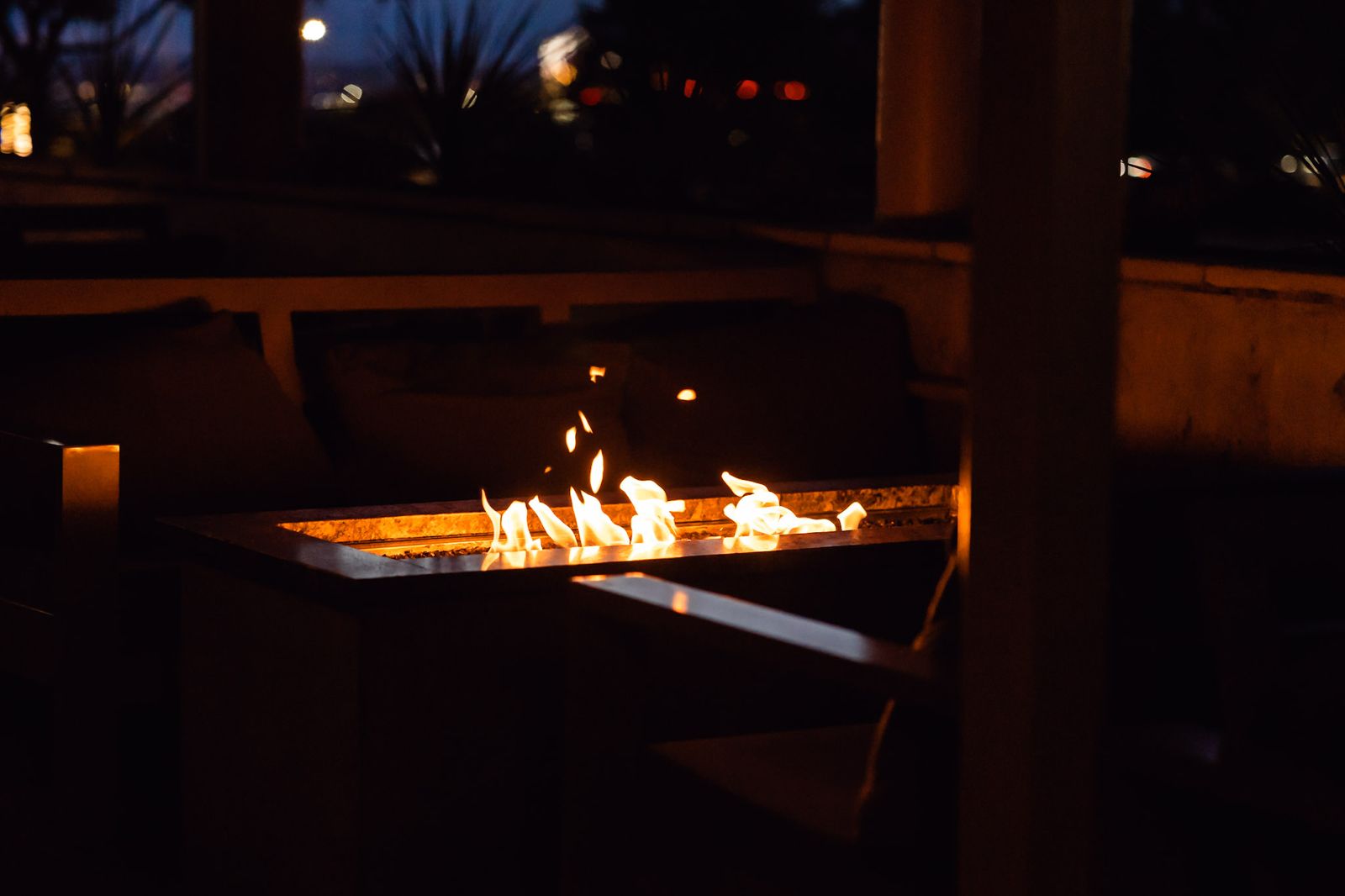 Patio fire pit glowing at night