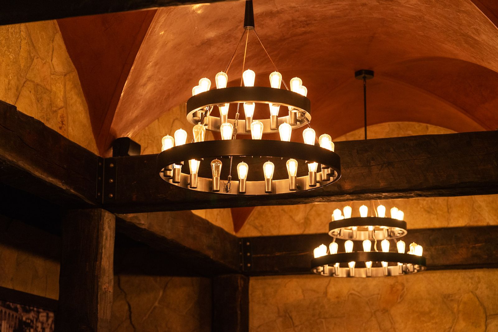 Tiered wagon-wheel chandeliers over the private dining room at Vintage 423