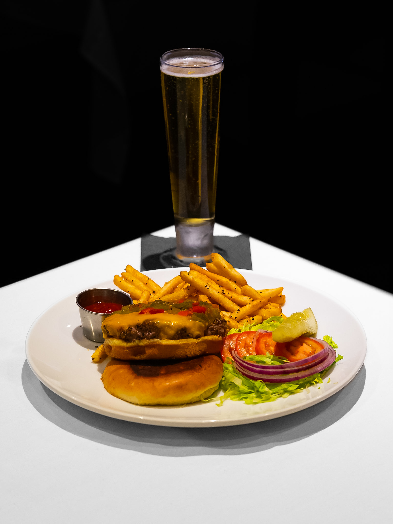 Vintage Burger with fries and a pilsner